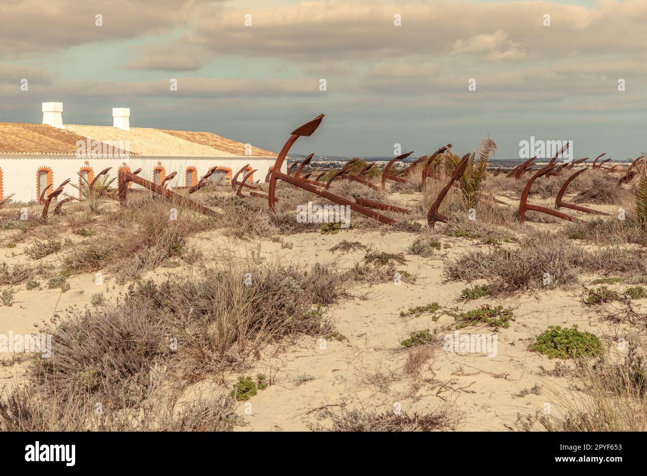 Cemetery of the old anchors of the former tuna fishing ships in the sand dunes on Barril beach Algarve Stock Photo