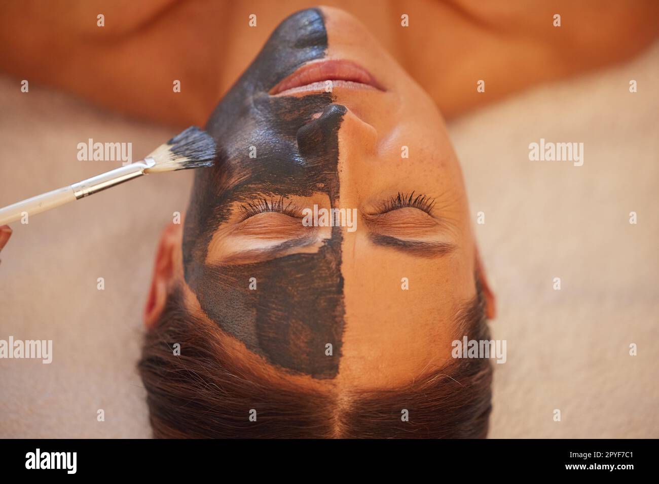 Spa, woman and charcoal face mask, skincare and luxury for health, wellness and clear skin. Beauty, cosmetics and girl with organic facial, healthcare and detox for cosmetology, acne and massage. Stock Photo