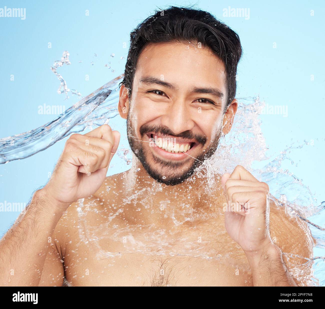 Dental, teeth floss and water splash with man in portrait for hygiene, cleaning and oral healthcare against studio background. Teeth whitening, clean mouth and fresh breath with smile and Invisalign Stock Photo