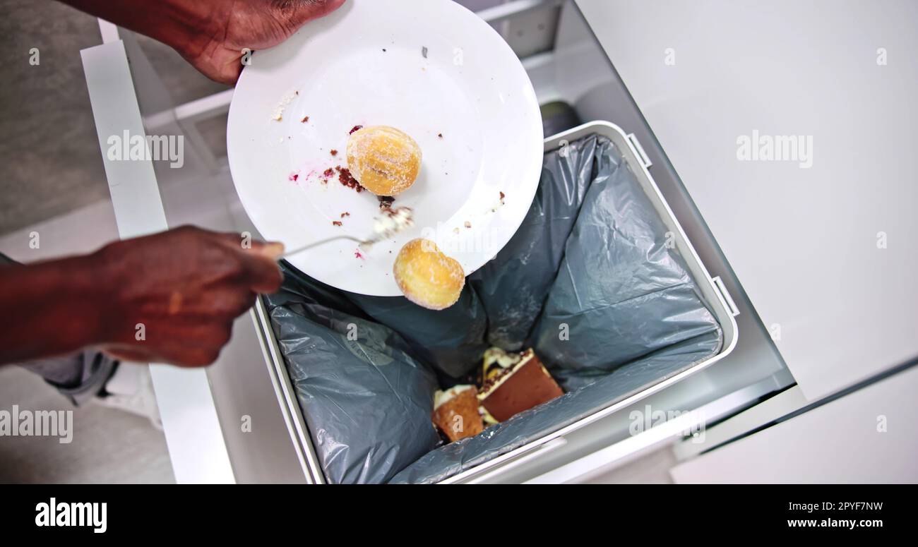 Throwing Away Leftover Food In Trash Stock Photo Alamy
