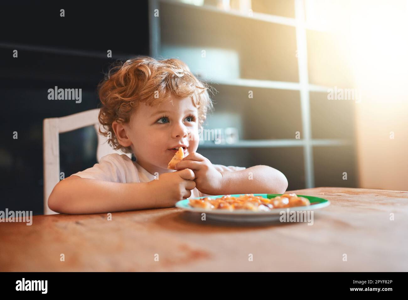 I love Moms cooking. an adorable little boy eating at home. Stock Photo