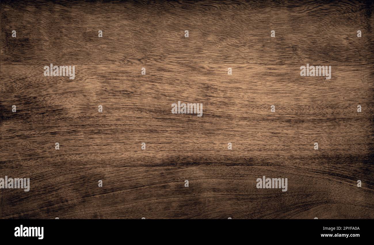 Dark brown rough grainy mango wood texture background Stock Photo