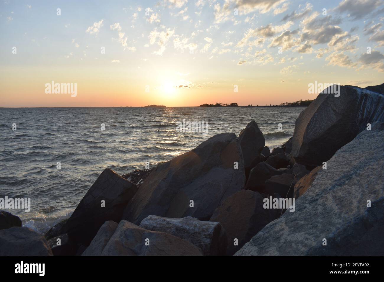 Large boulders line the shore at a Sandy Hook, New Jersey, bayside