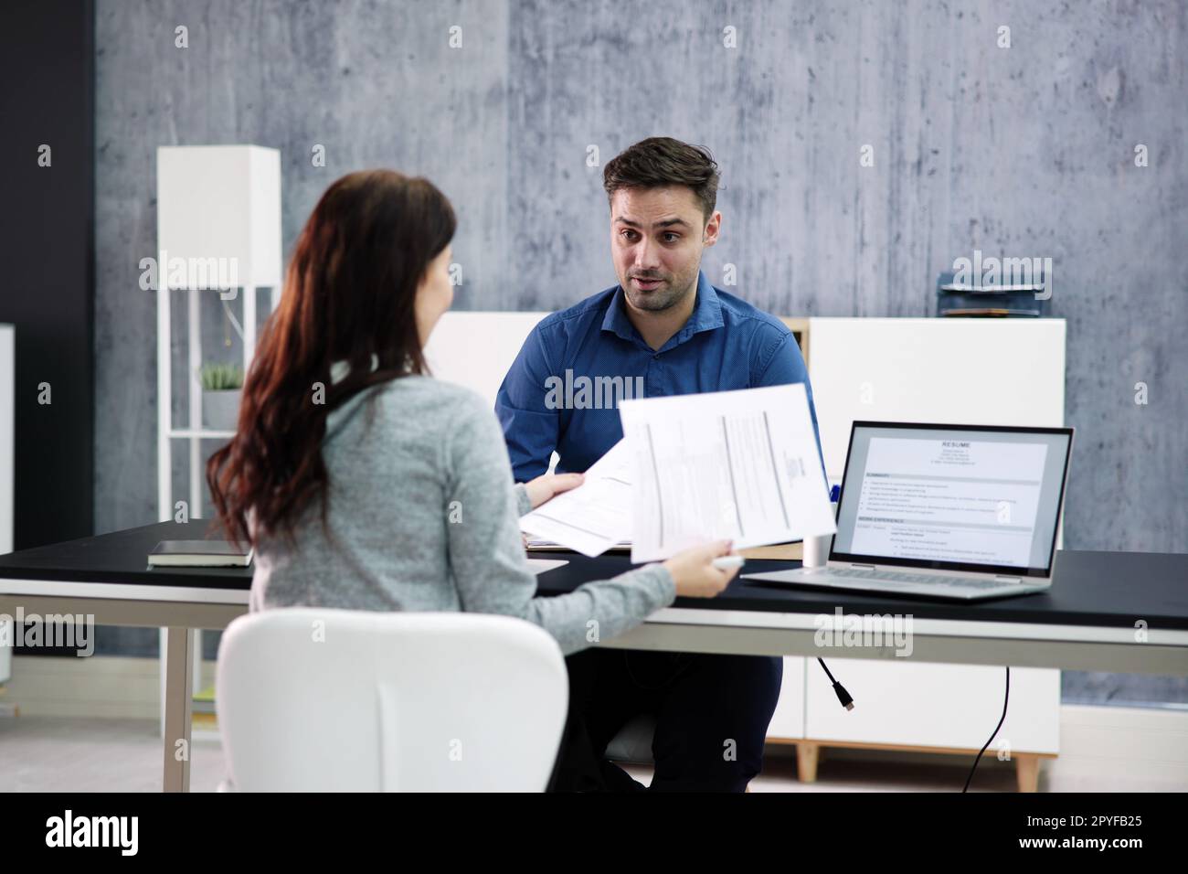 Two Businesspeople Talking With Each Other Stock Photo