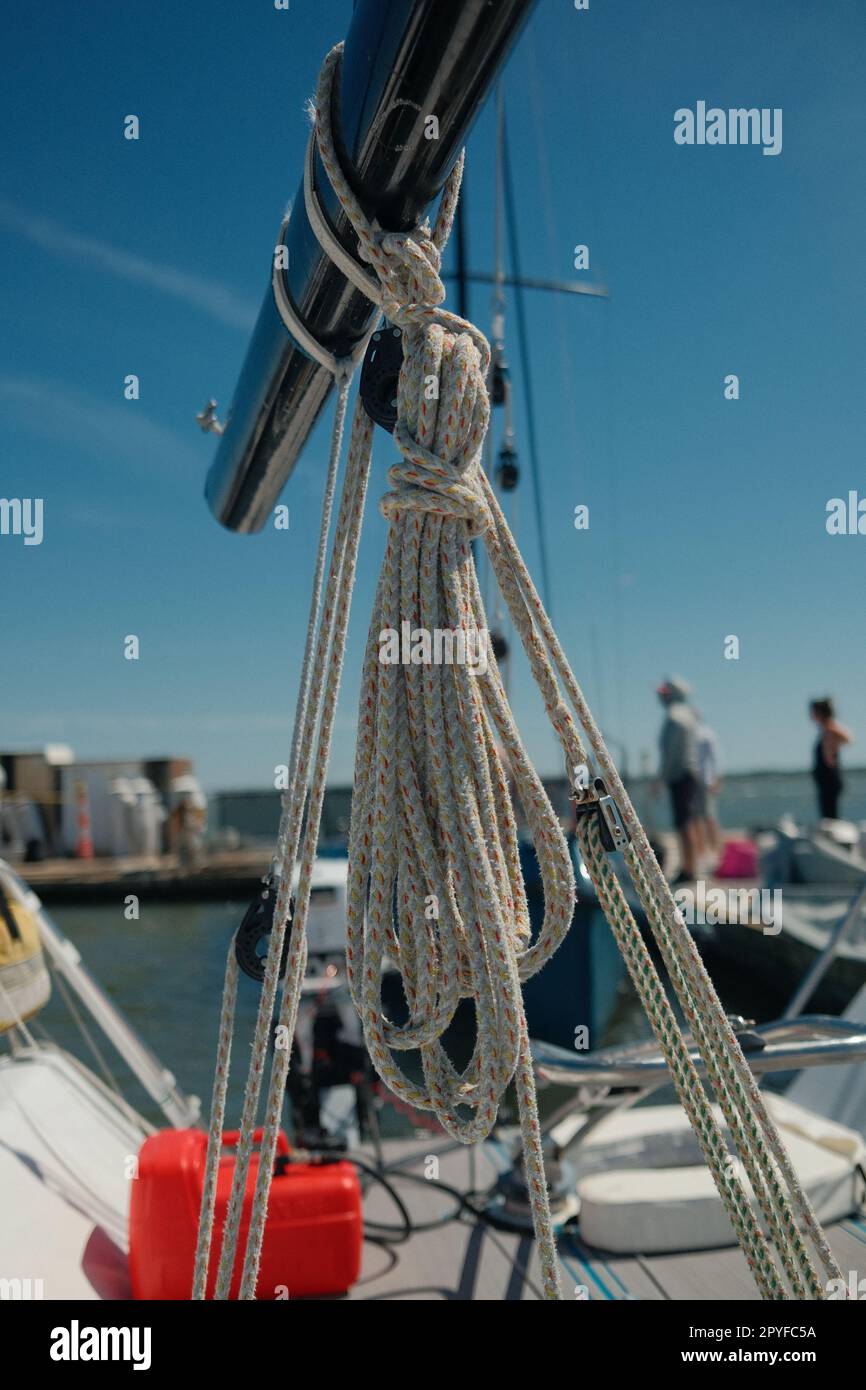 Stock photo of a boat docked in a harbor with a rope tied around the