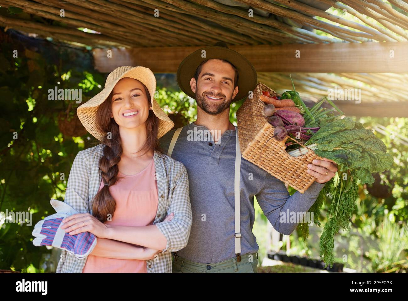 Dont panic, theyre organic. Portrait of a happy couple working together in a vegetable garden. Stock Photo