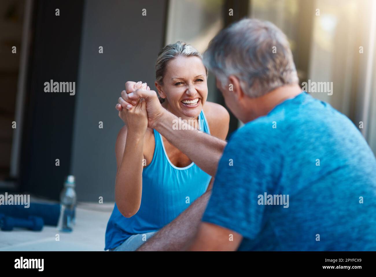 Teamwork makes the dream work. a mature and motivated couple congratulating each other at the end of an intense workout session. Stock Photo
