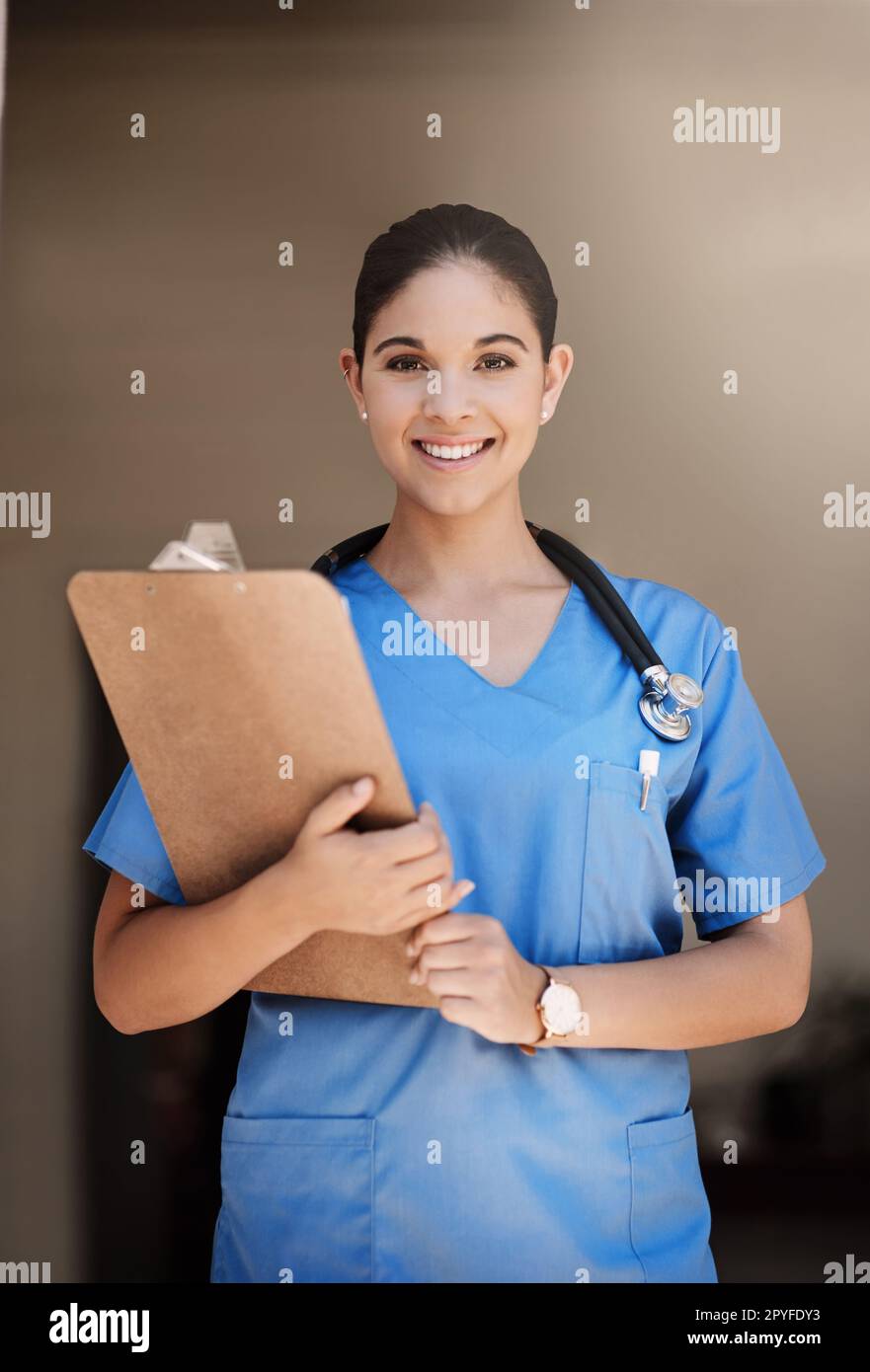Let me guide you with your health concerns. Cropped portrait of an attractive young female medical practitioner holding a clipboard in a hospital. Stock Photo