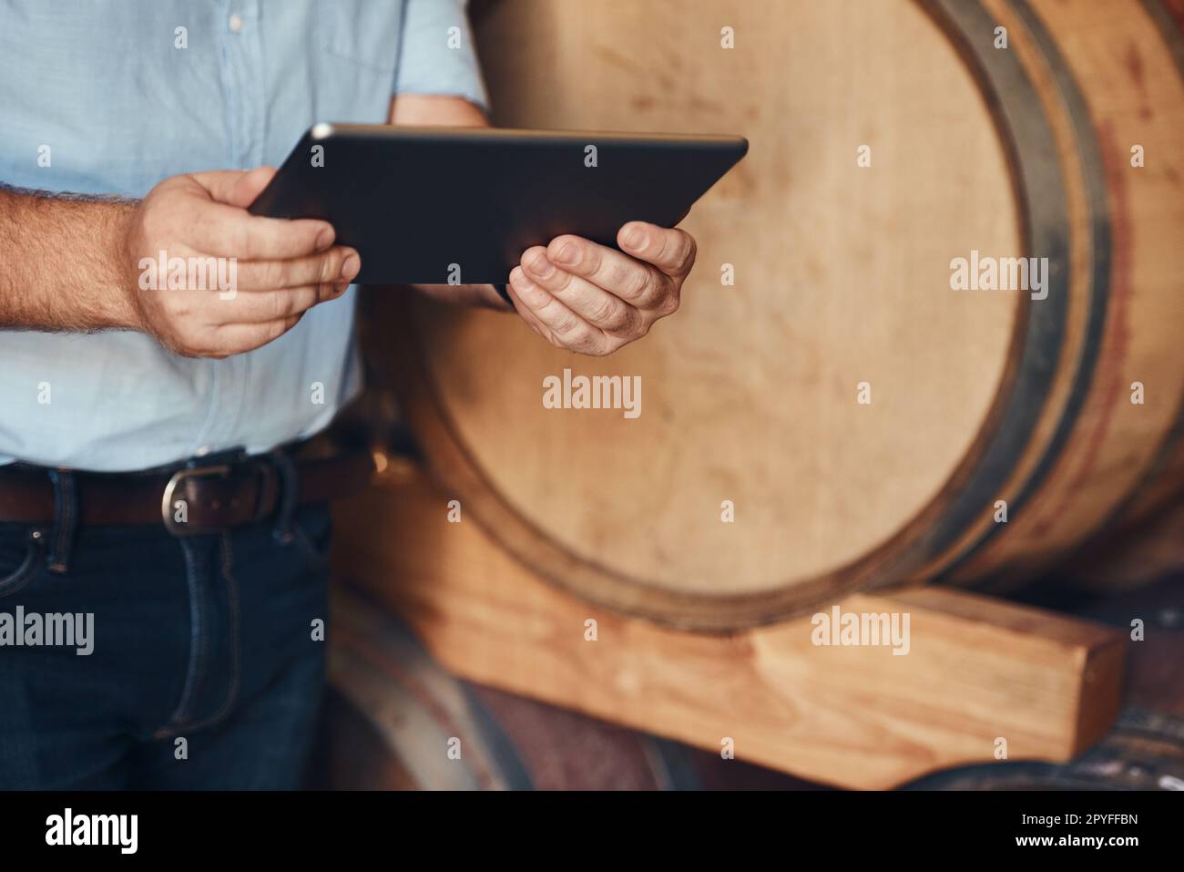 Find out all you need to know about wine online. an unrecognizable male sommelier using his digital tablet at work. Stock Photo