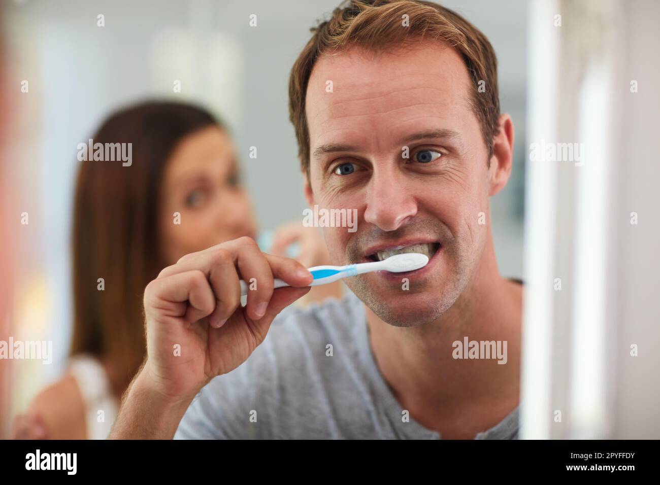 Freshening up for the day ahead. a mature couple brushing their teeth together in the bathroom. Stock Photo