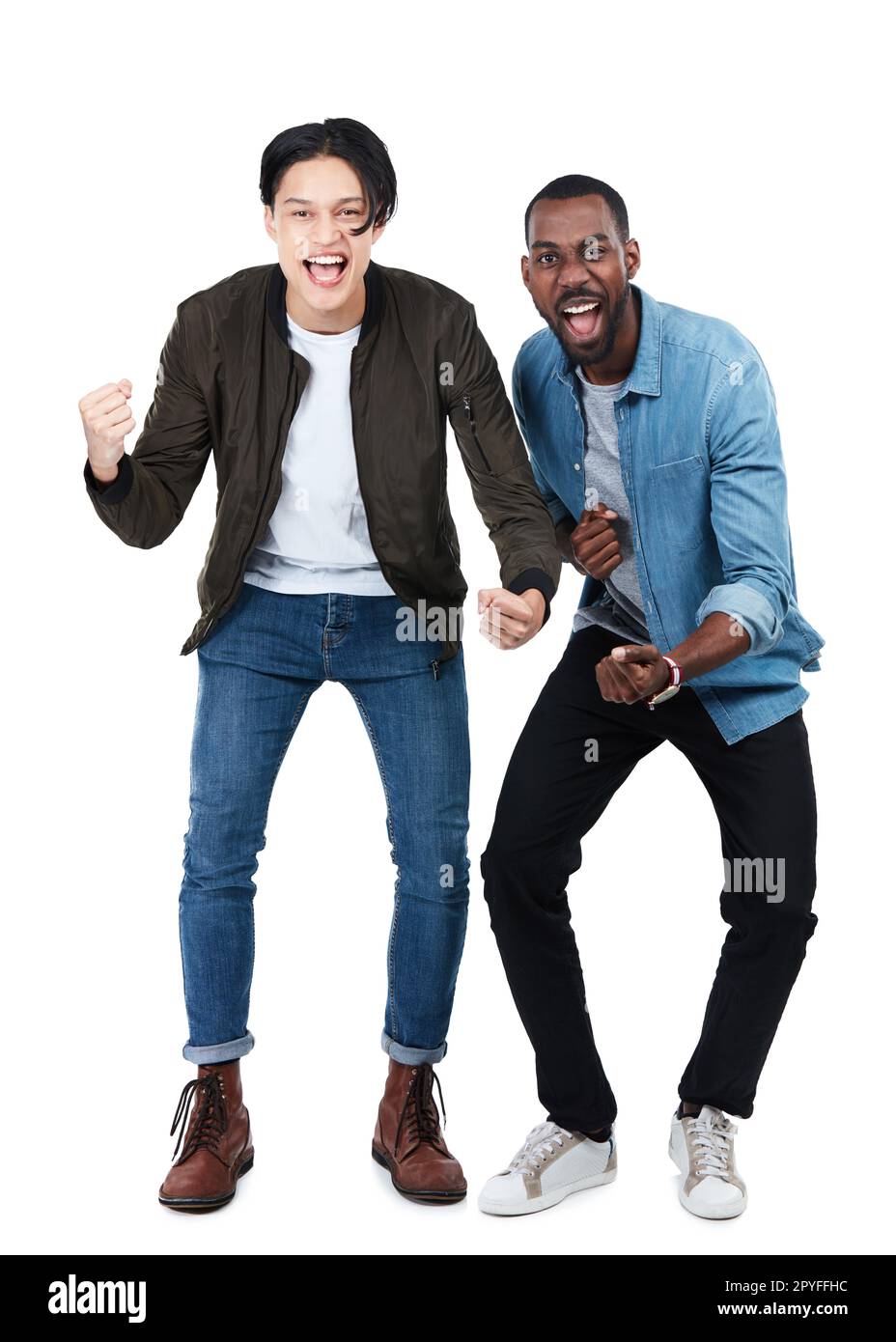 Two alternative friends wearing yellow and pink jeans clothes, posing,  raising arms - a Royalty Free Stock Photo from Photocase
