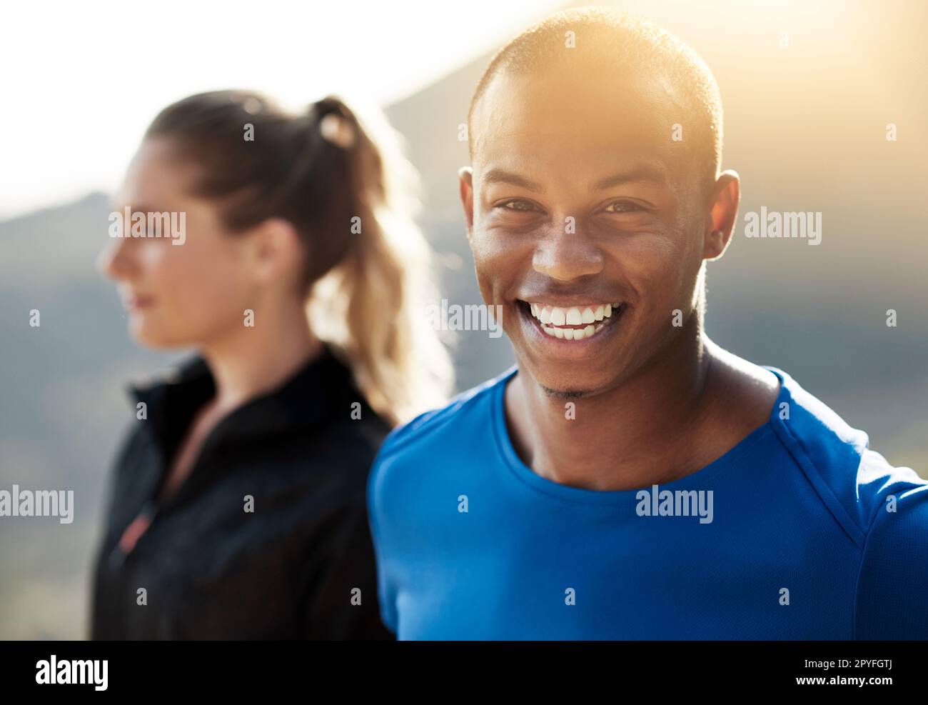If you can walk, you can run. two athletes standing outdoors. Stock Photo