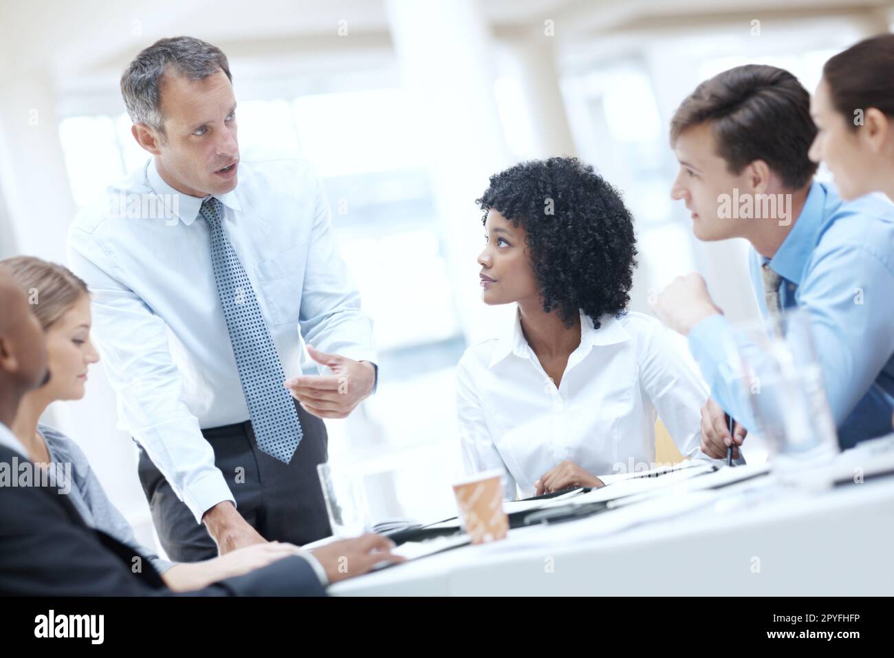 I believe we need to start moving into new markets. A multi-ethnic group of businesspeople being addressed by their boss during a meeting. Stock Photo
