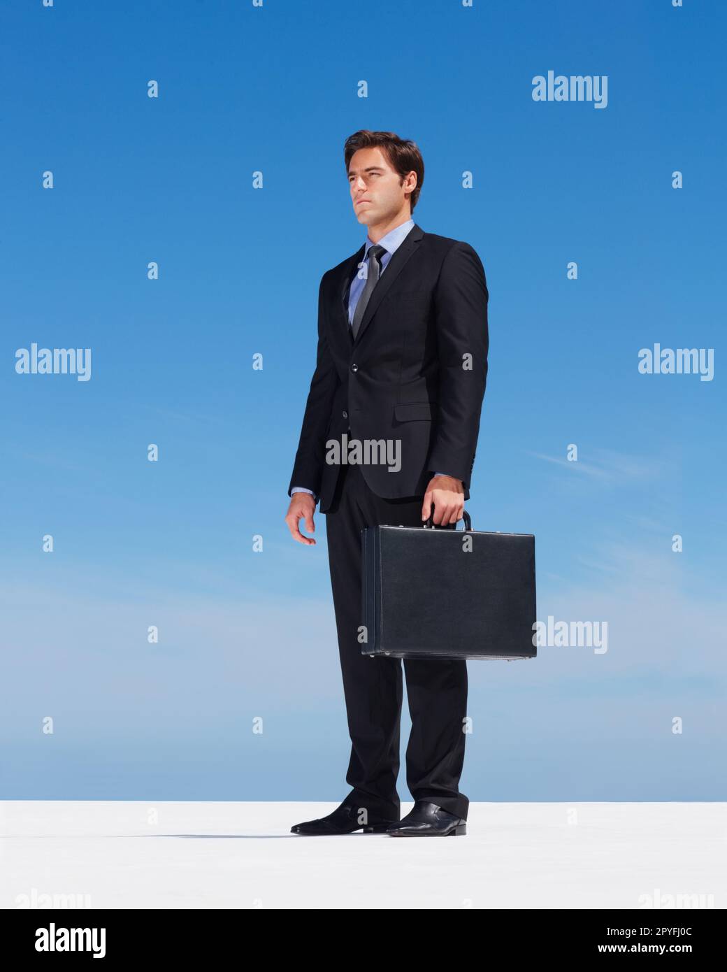 Successful business man standing by the sea. Portrait of a successful business man standing by the sea. Stock Photo