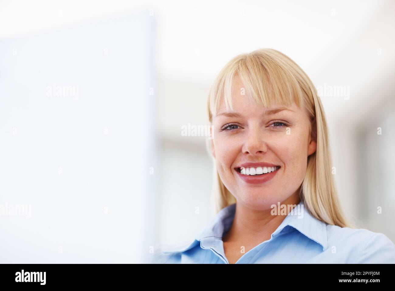 Young business woman with a cute smile. Closeup of pretty young business woman smiling - copyspace. Stock Photo