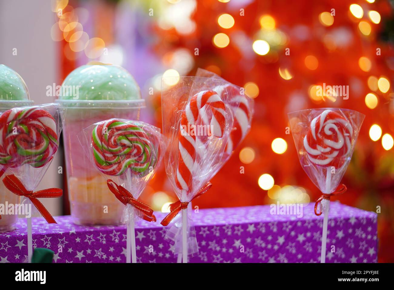 Red and white Christmas candy and lollipop with red blur background