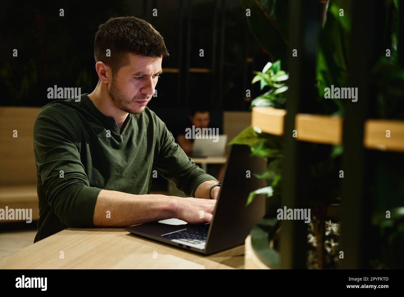 Male hands typing on laptop keyboard, close up. Man using laptop in ...