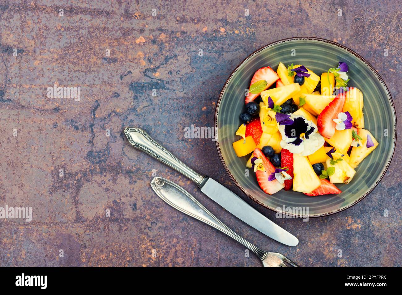 Fruit salad decorated with flowers Stock Photo Alamy