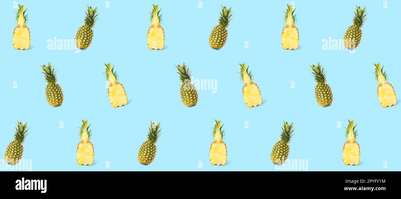 Many ripe pineapples on light blue background. Pattern for design Stock Photo