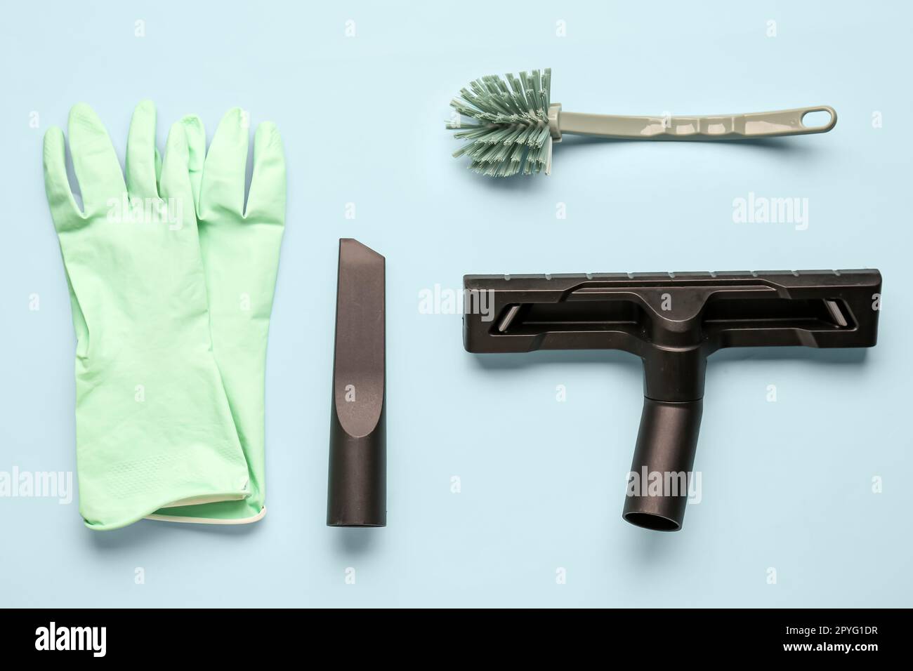 Vacuum cleaner attachments with rubber gloves and brush on blue