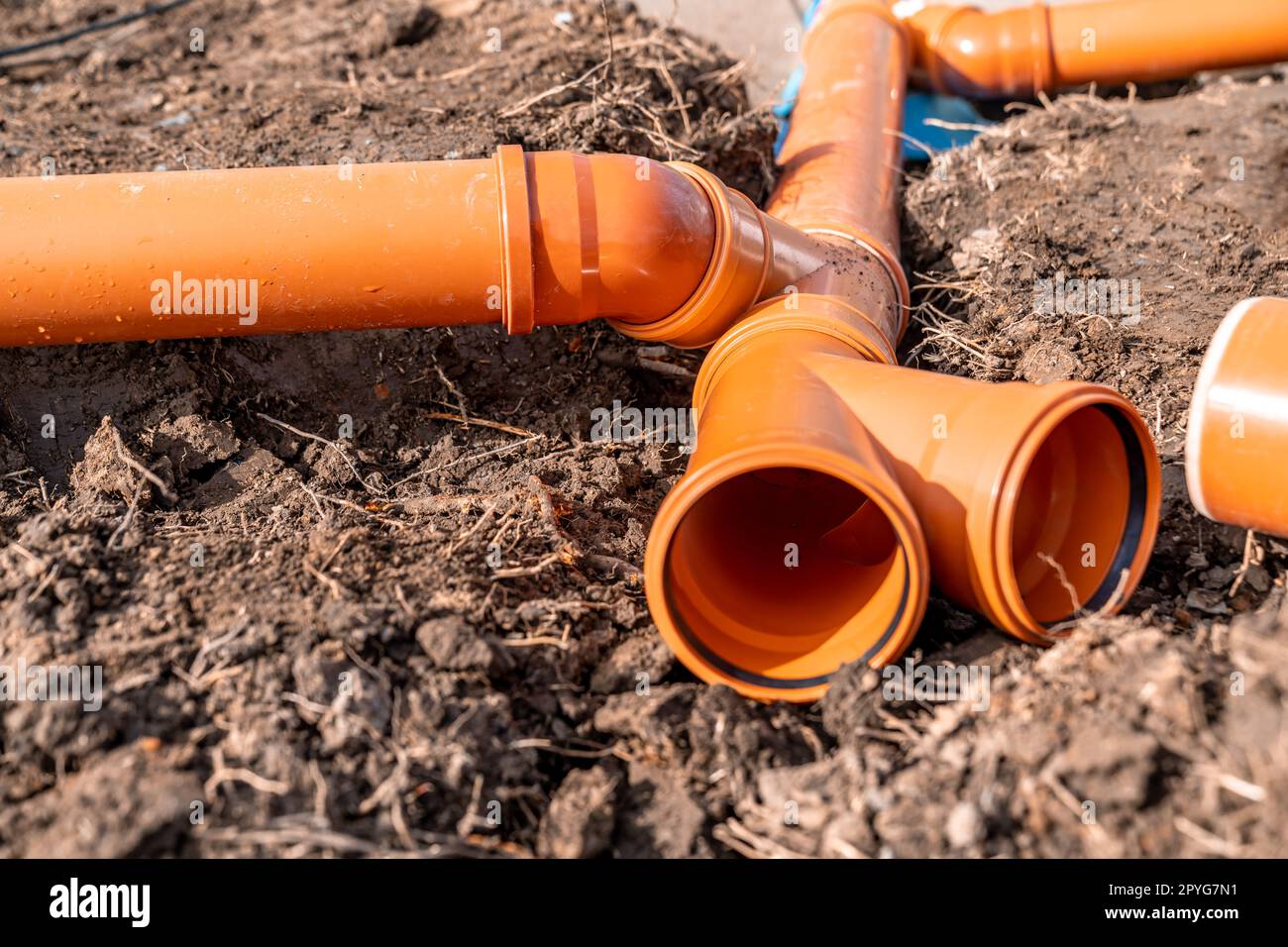 orange plastic PVC pipes in the ground Stock Photo Alamy