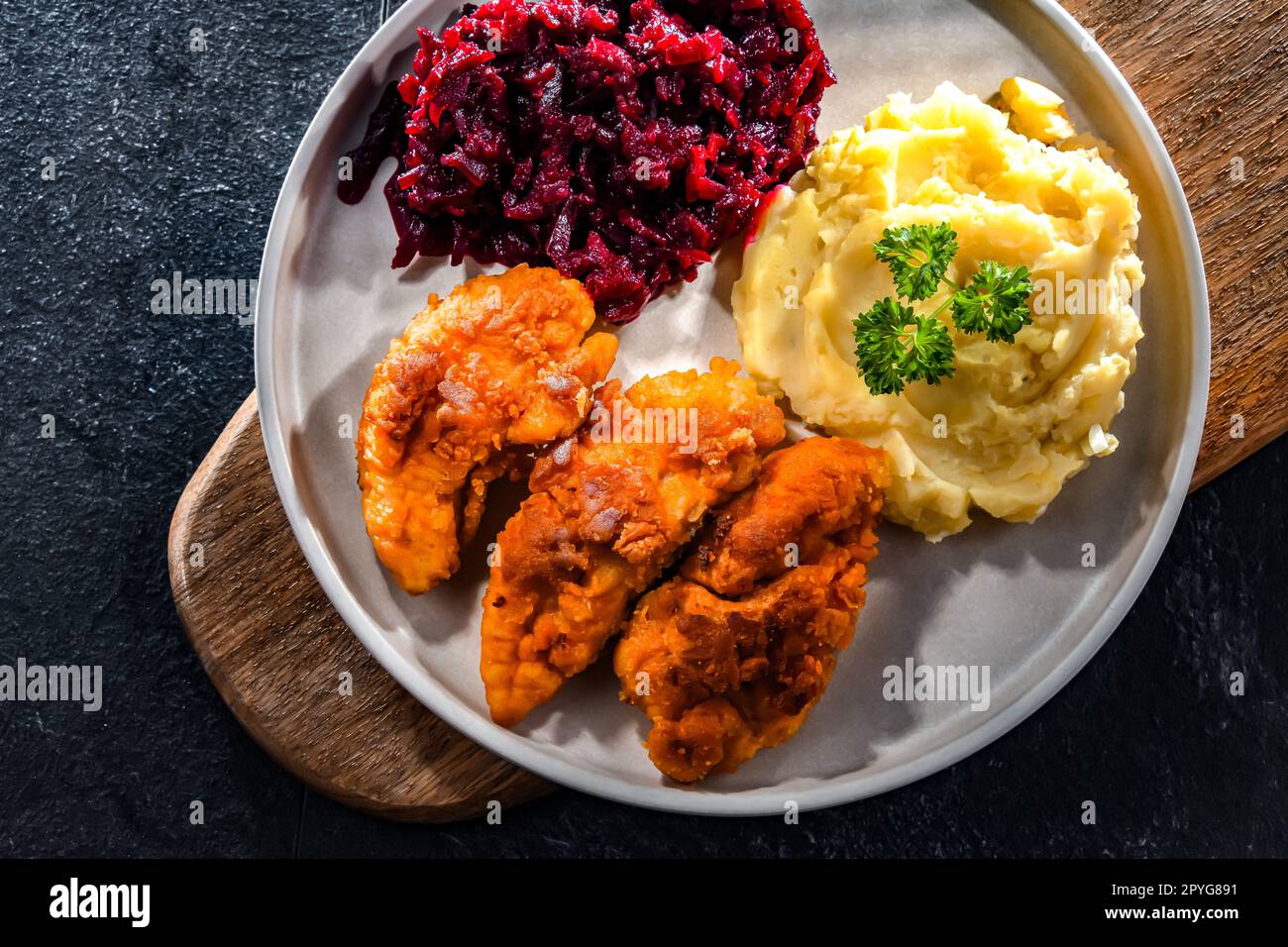 Breaded chicken cutlets served with potatoes and beetroot Stock Photo