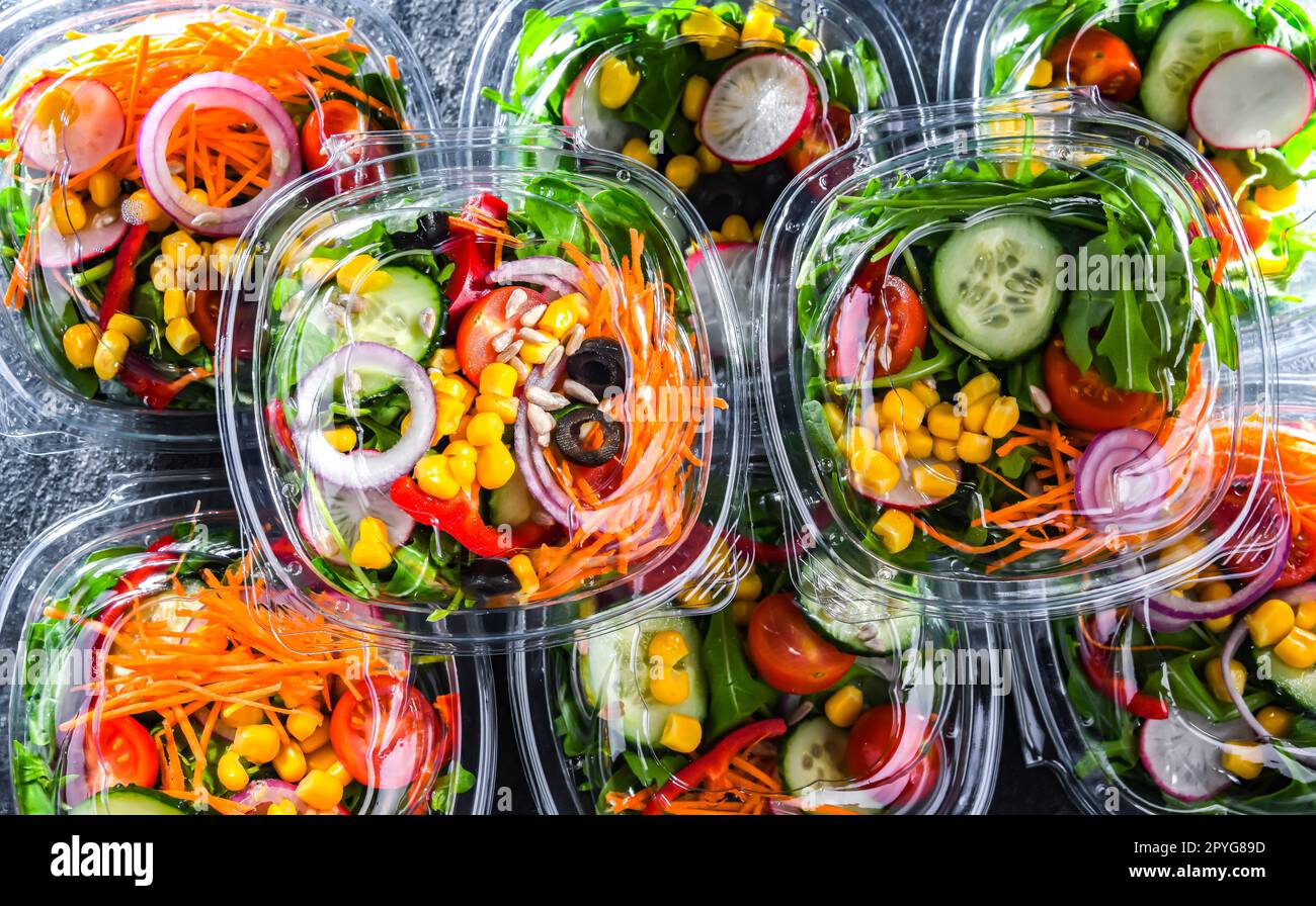 Boxes with pre-packaged vegetable salads in a commercial fridge Stock Photo