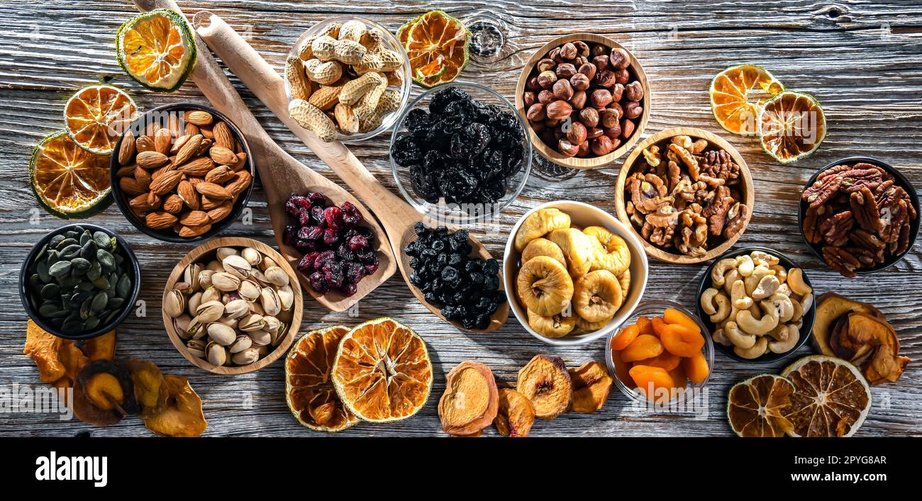 Composition with a variety of dried fruits and assorted nuts. Stock Photo