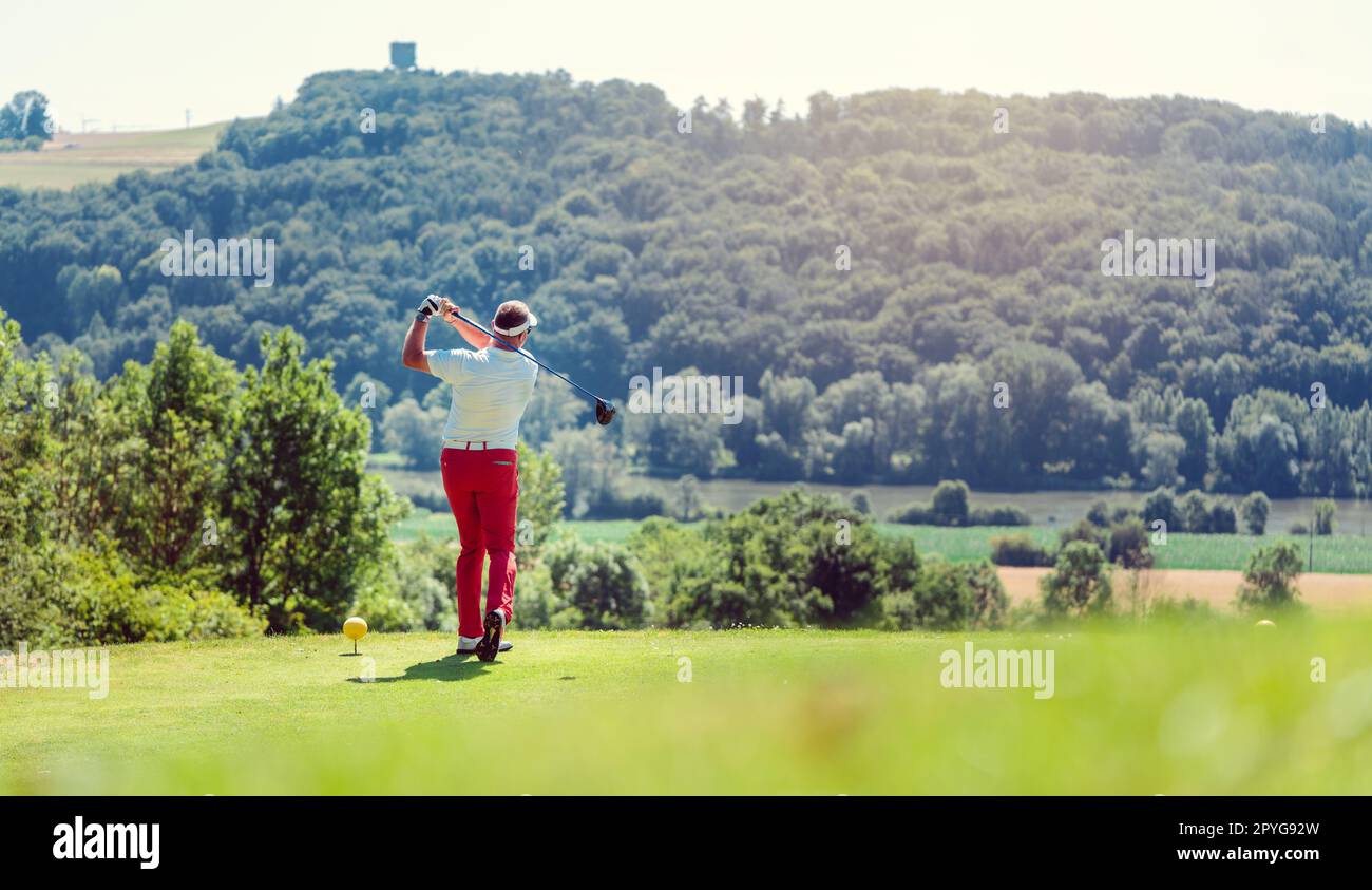 Golf player hitting ball long with driver Stock Photo Alamy