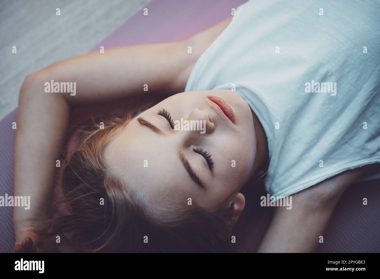 Happy child meditating on yoga mat Stock Photo