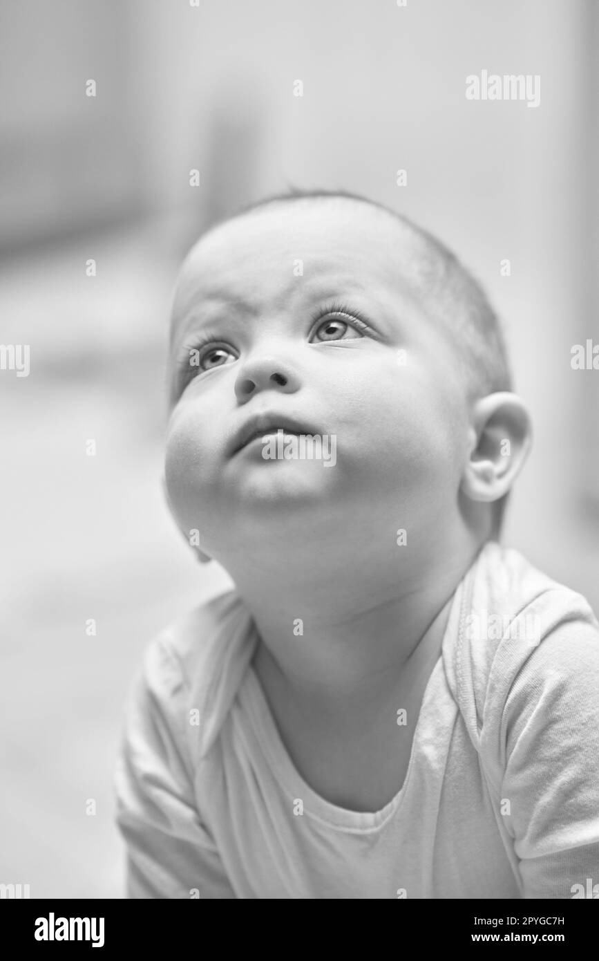 portrait of cute baby girl looks up Stock Photo Alamy