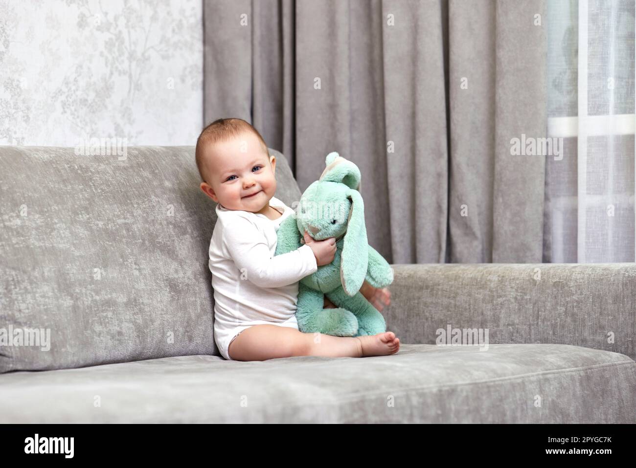 cute baby girl playing with soft toy bunny Stock Photo Alamy