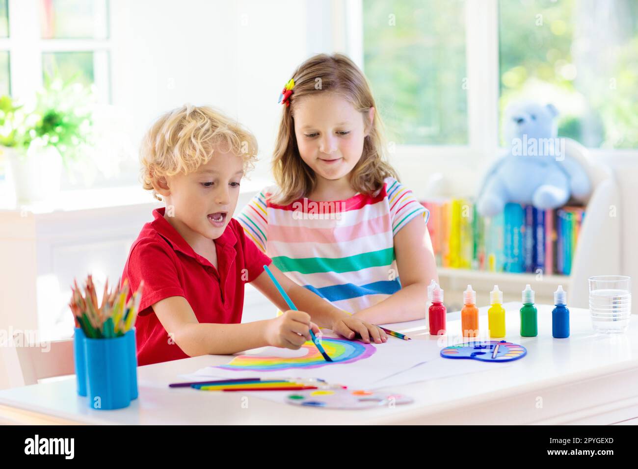 Kids paint. Child painting in white sunny study room. Little boy and