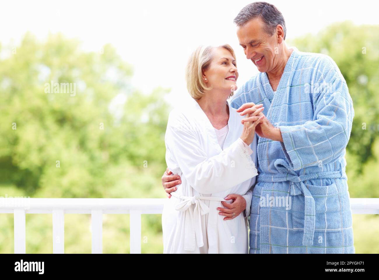 Happy senior couple in a romantic mood holding hands. Portrait of a happy senior couple in a romantic mood holding hands. Stock Photo