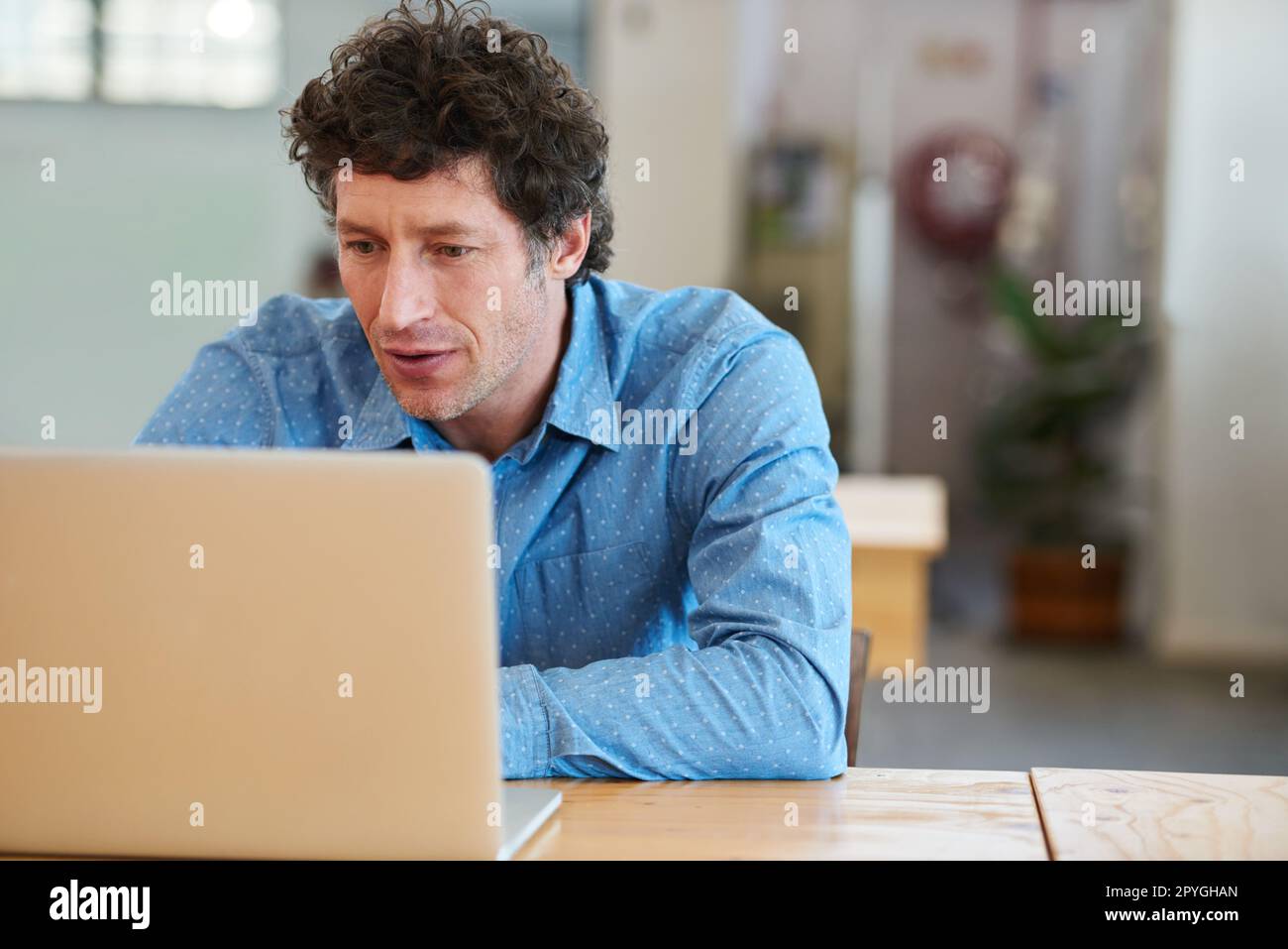 Answering client questions online. a handsome businessman working in the office. Stock Photo