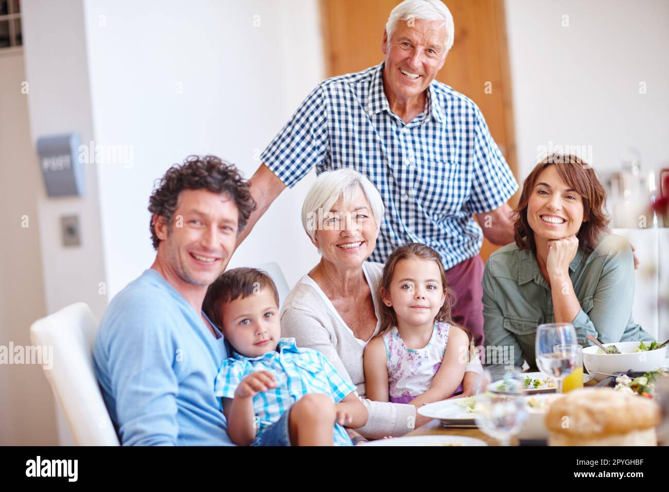 Good food brings families together. a multi-generational family having a meal together. Stock Photo