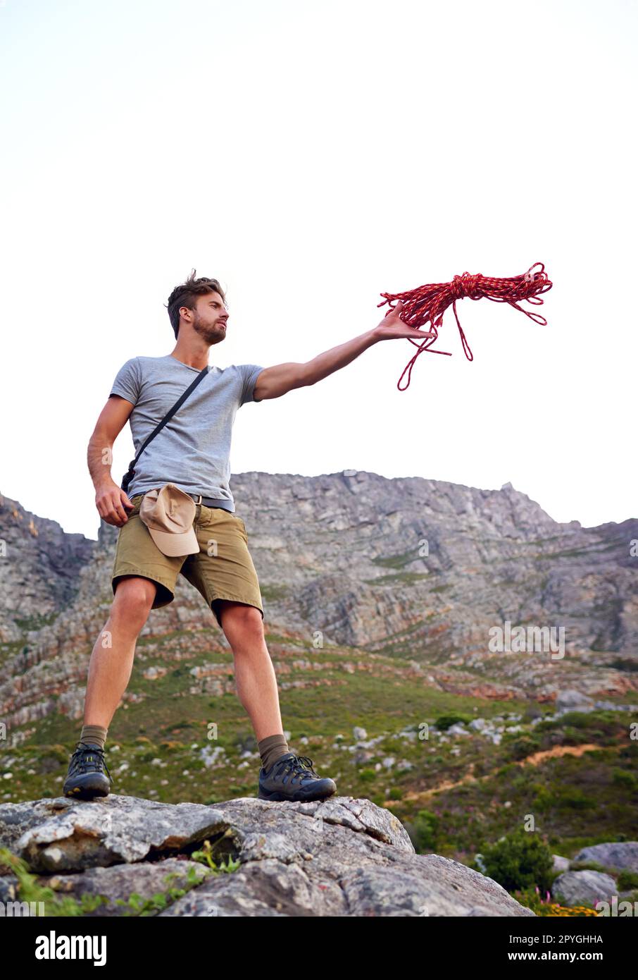 Dont forget your rope. Full length shot of a handsome young man throwing a  rope while hiking Stock Photo - Alamy