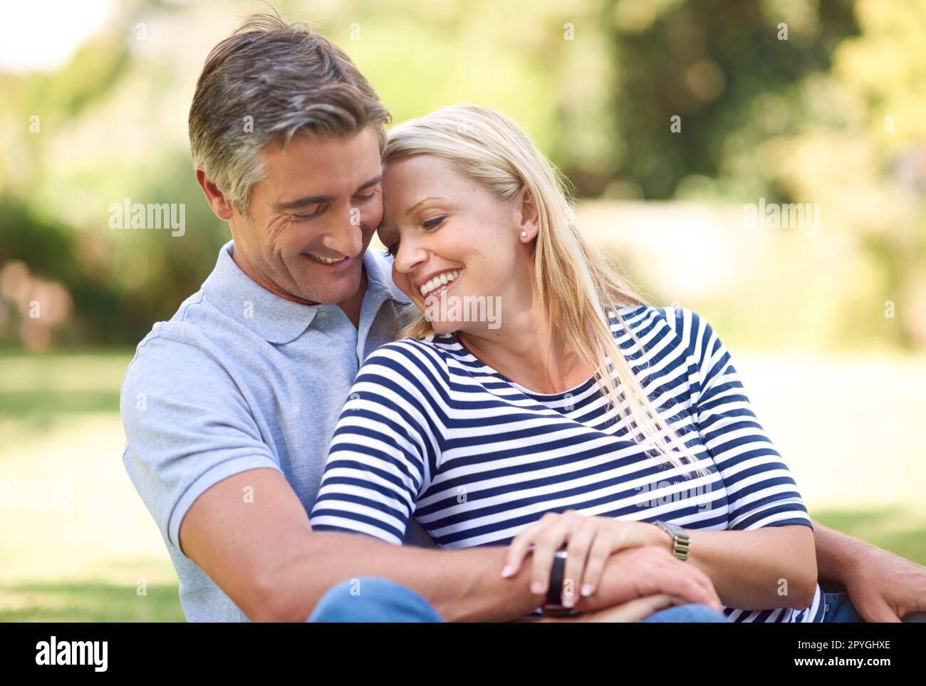 Enjoying a placid day at the park. an affectionate mature couple in the park. Stock Photo