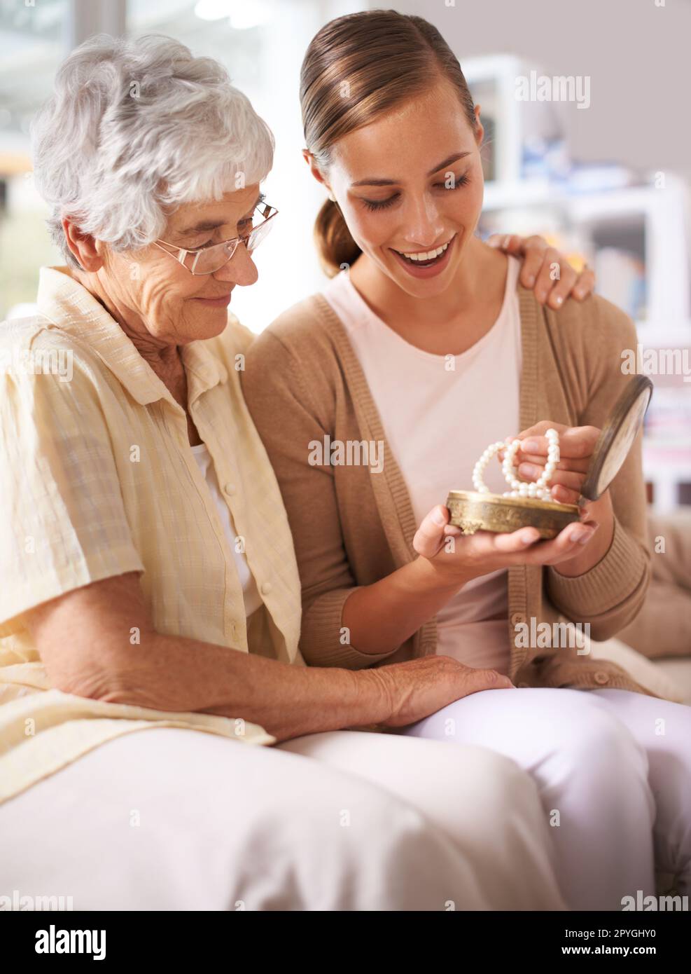 Pearls for my precious. a senior woman giving her daughter a pearl necklace. Stock Photo