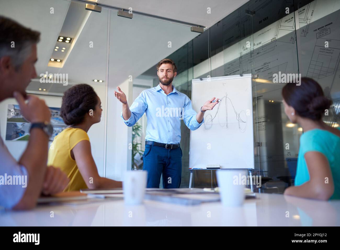 My idea is big. a handsome young man giving a business presentation. Stock Photo