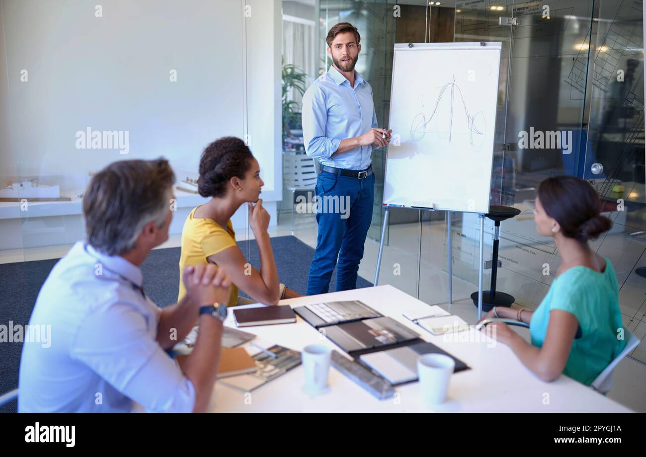 Questions. a handsome young man giving a business presentation. Stock Photo