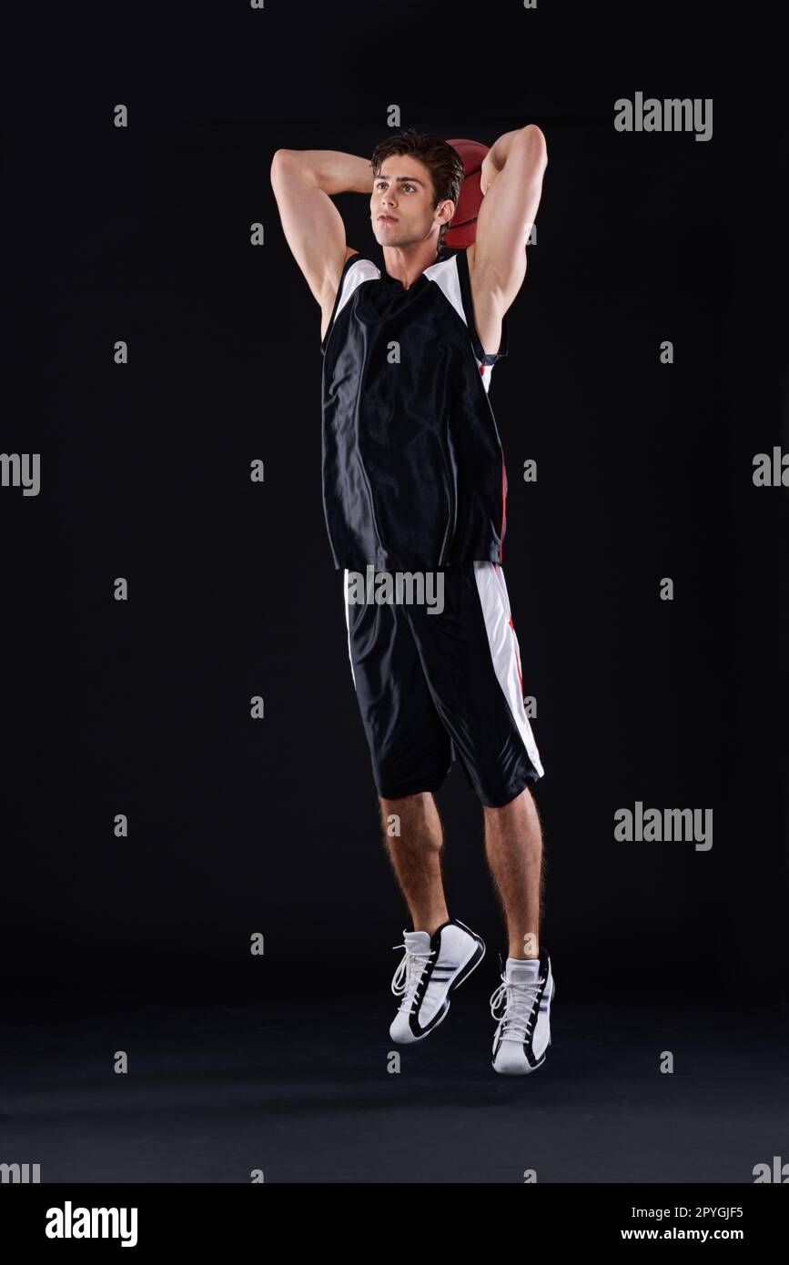 Will he make the shot. Full length studio shot of a male basketball player ready to take a shot. Stock Photo