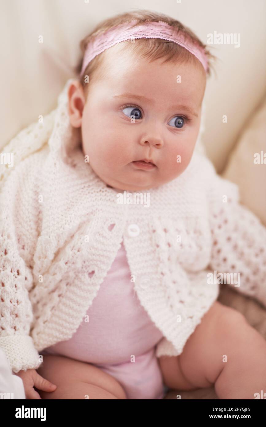 Shes such an angel. an adorable baby girl looking to the side. Stock Photo