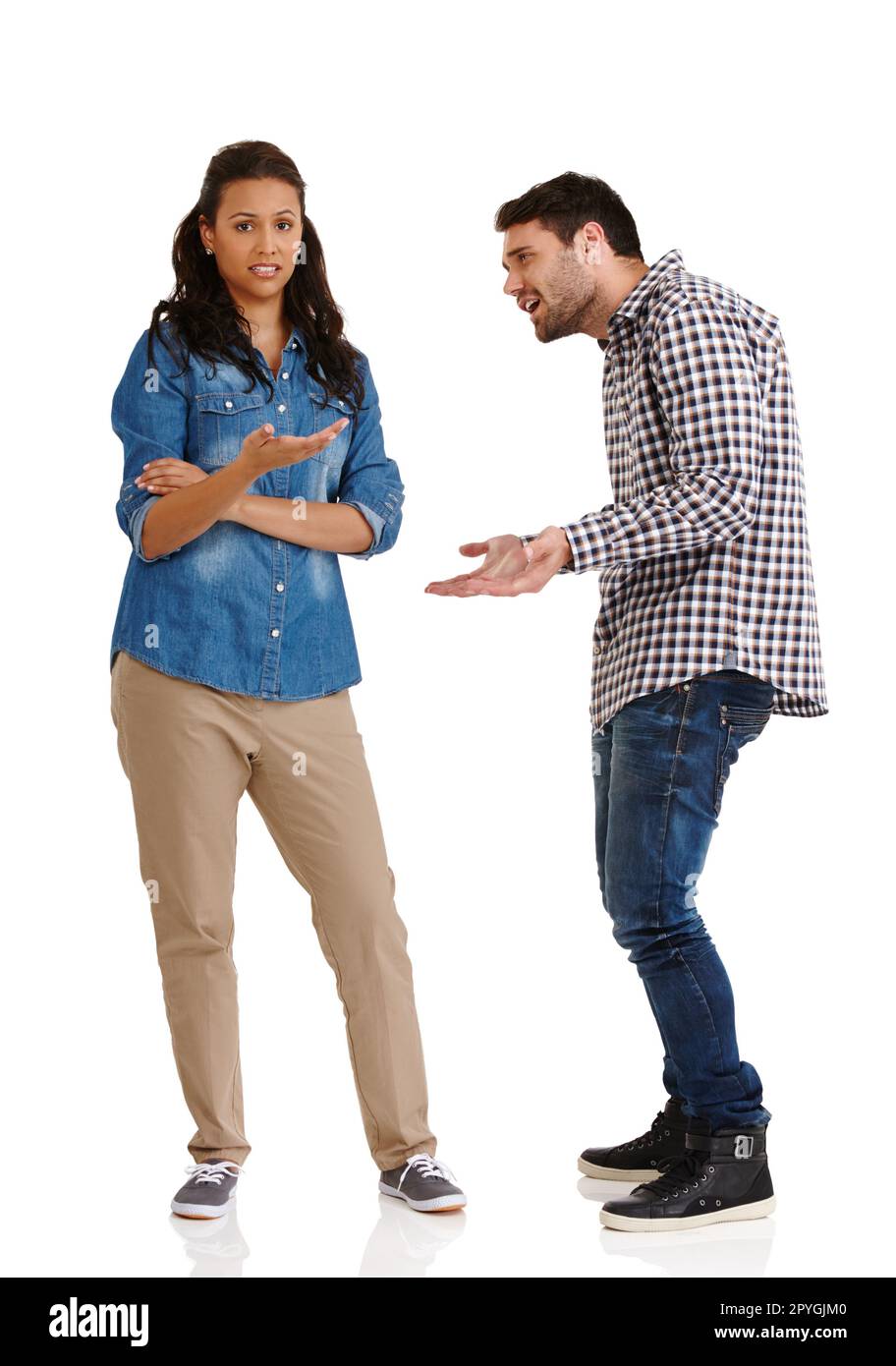 Please try to understand. Studio shot of a young man pleading his case to his wife isolated on white. Stock Photo