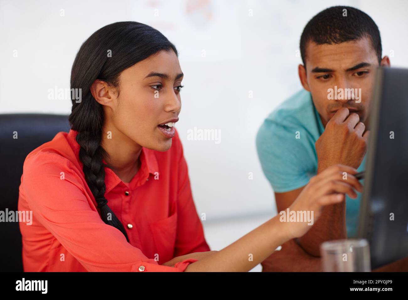 Paying attention to the details. two young designers working together at a computer. Stock Photo
