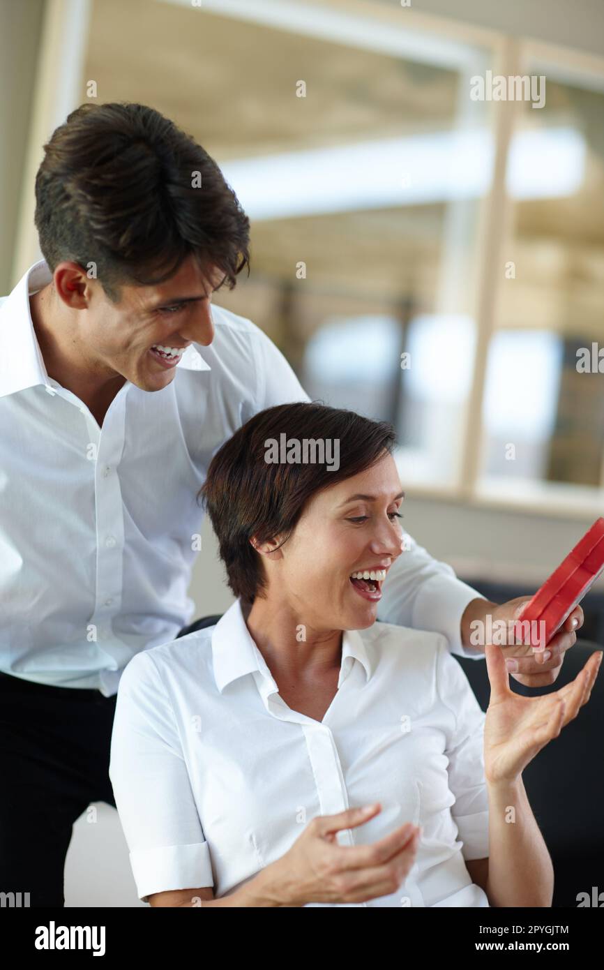 You shouldnt have. a young man giving his girlfriend a box of chocolates. Stock Photo