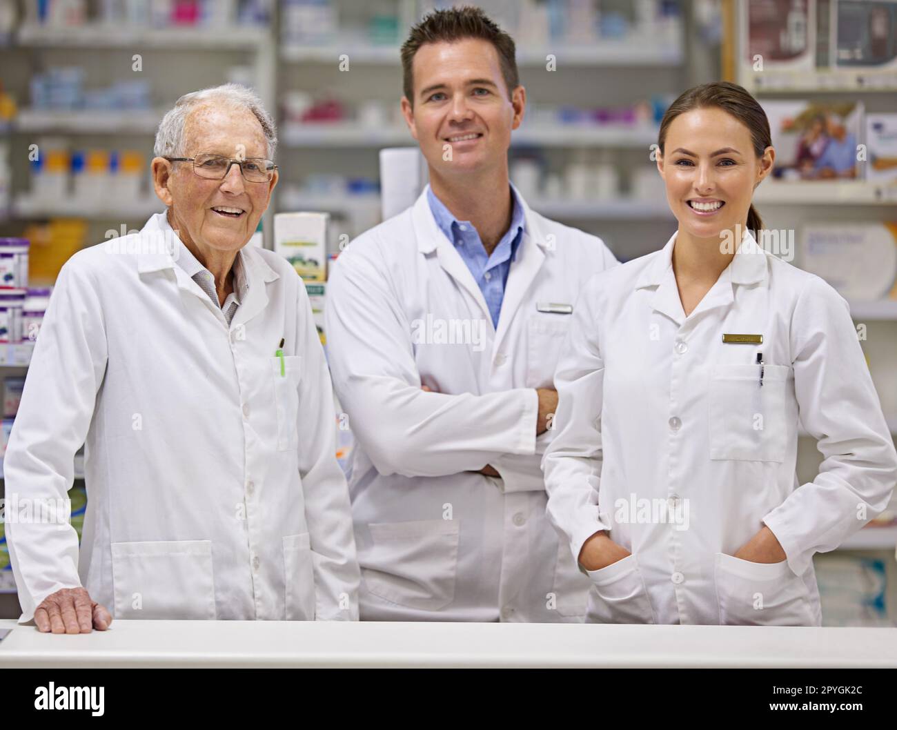 Medicinal wisdom and experience. Portrait of three pharmacists standing at a counter. Stock Photo