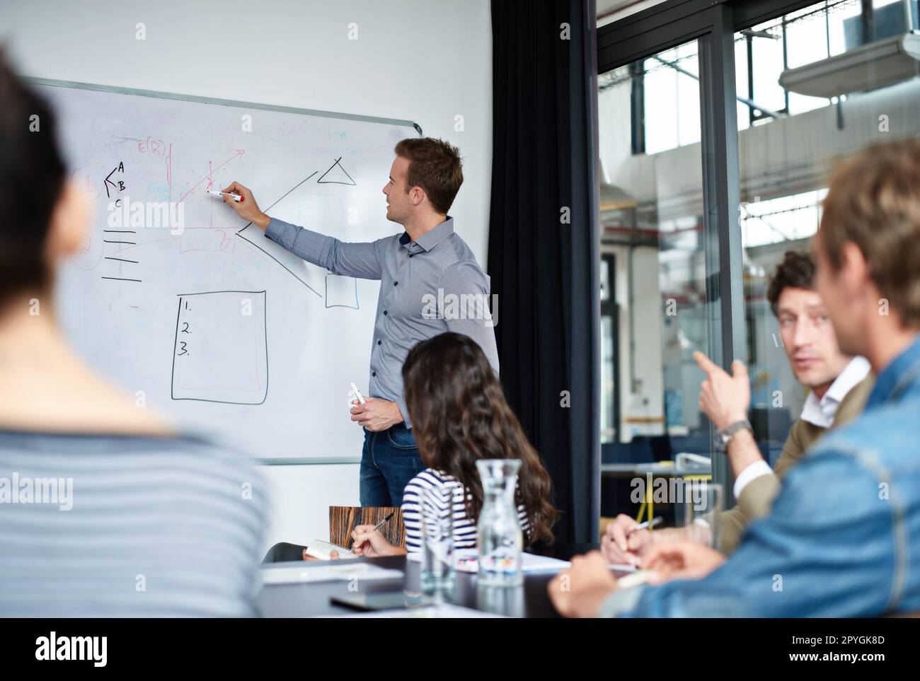 Moving his company forward. a diverse group of colleagues in a presentation. Stock Photo