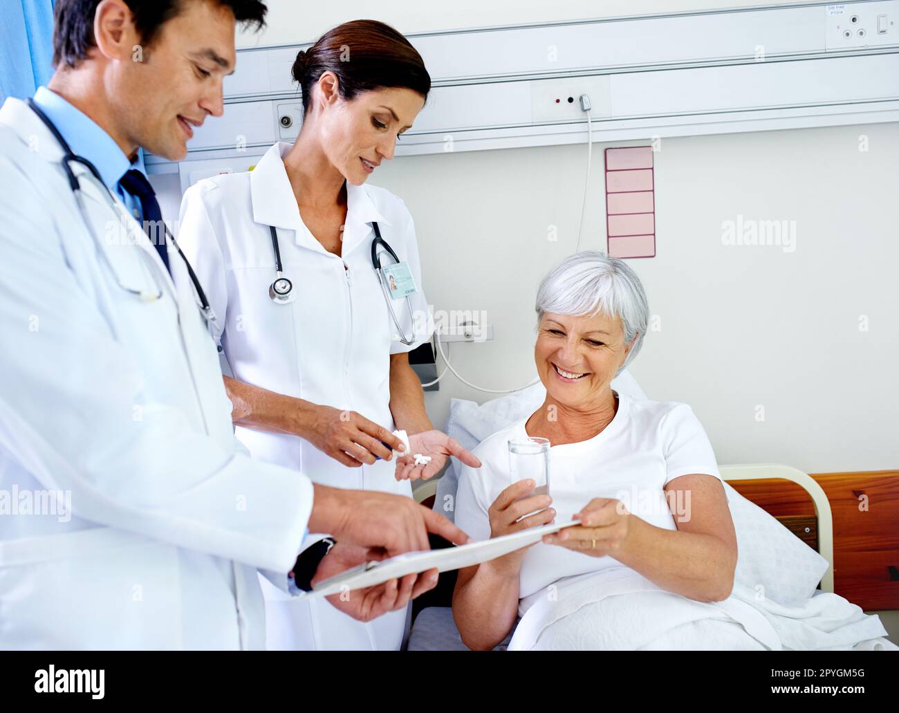 Keeping her comfortable and informed. two doctors attending their