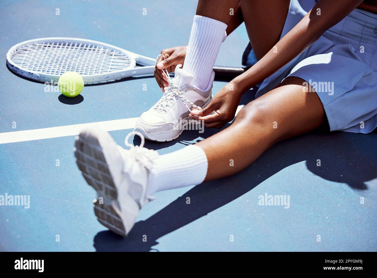 Tennis player woman, shoelace and ready for game, training or exercise sneakers in development, sports or focus. Sport expert, girl athlete and professional shoes with tennis ball, racket and goals Stock Photo